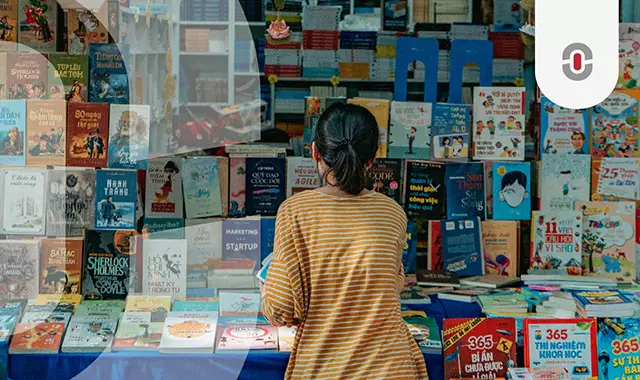 A woman in a striped shirt browsing a vibrant selection of Vietnamese books at a bookstore. The image highlights the richness of Vietnamese literature and the importance of translation in making content accessible across languages.