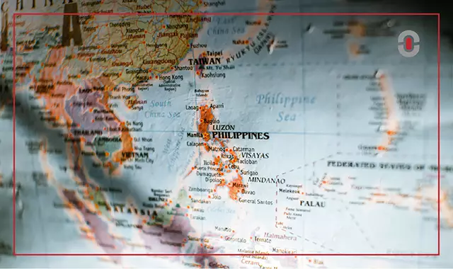 A close-up of a physical map highlighting the Philippines, with major cities and regions visible, including Luzon, Visayas, and Mindanao. This image represents the country’s geographical and linguistic diversity.