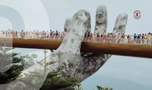 Tourists walking along the iconic Golden Bridge held by giant stone hands in Da Nang, Vietnam—representing Central Vietnam’s cultural and linguistic uniqueness.